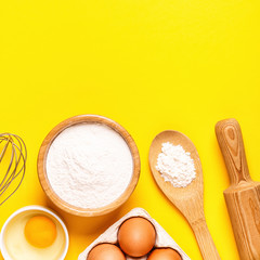 Ingredients and utensils for baking on a pastel background.