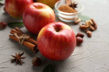 Fresh ripe apples and cinnamon on light background