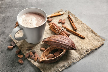 Fototapeta na wymiar Composition with cup of delicious hot cocoa on grey background