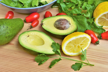 Fresh avocado cut in half and  sprinkled with lemon juice, on a kitchen table.