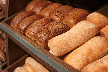 Delicious fresh bread on shelf in bakery