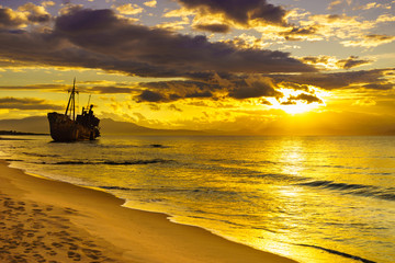 Rusty broken shipwreck on sea shore