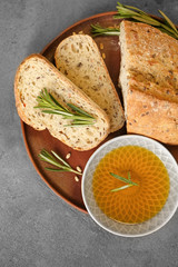 Plate with fresh tasty bread and oil on table