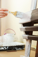 Person renovating wooden hanger