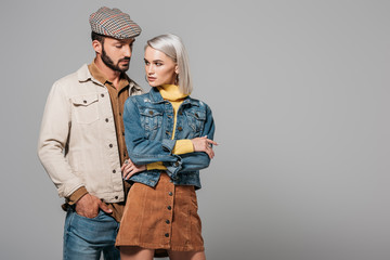 elegant stylish couple posing in autumn outfit, isolated on grey