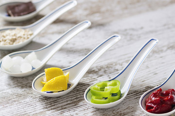 Porcelain spoons with doos ingredients