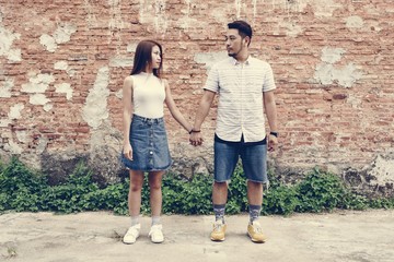 Obraz na płótnie Canvas Asian couple holding hands together