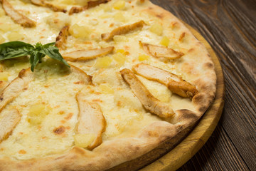 Pizza with chicken breast, pineapple and mozzarella cheese