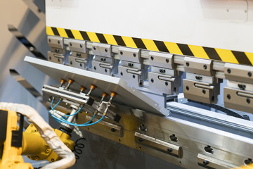 operator bending metal sheet by sheet bending machine