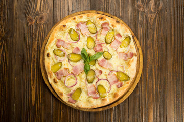 pizza with bacon and pickled cucumbers