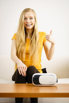 Happy young woman next to VR