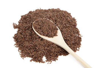 Flax seeds in a wooden spoon on white isolated background