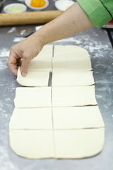 Cutting a puff pastry with a pizza knife - 216117359