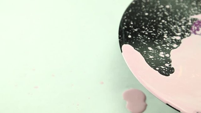 Reverse pink color paint splashing on vinyl record