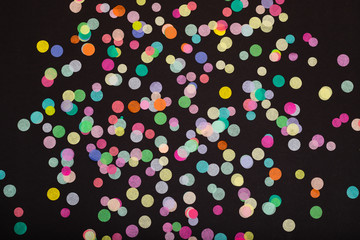 Fototapeta na wymiar Colorful confetti on black background