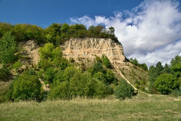 Old sandstone quarry overgrown with vegetation