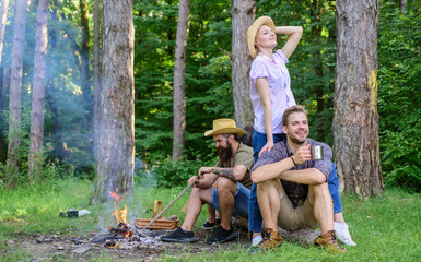 Company friends enjoy relaxing together forest. Company most important thing organizing vacation. Awesome hiking and great company. Friends relaxing near campfire after day hiking nature background