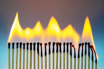 Burning matches on blue background