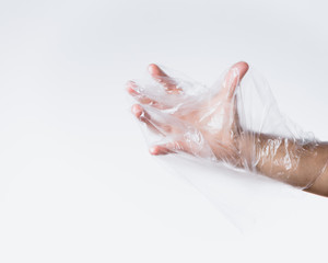 male hand struggling against plastic bag