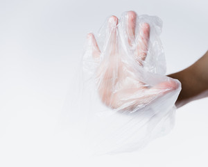 male hand in transparent plastic bag making stop sign