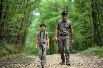 Ranger and his son in the woods