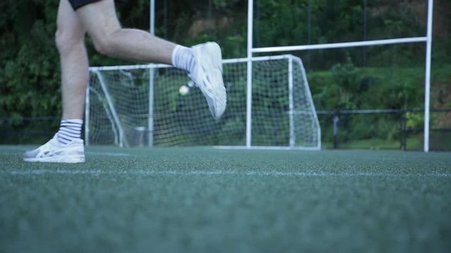 Football being kicked at goal, slow motion