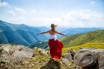 Young woman on the top of mountain