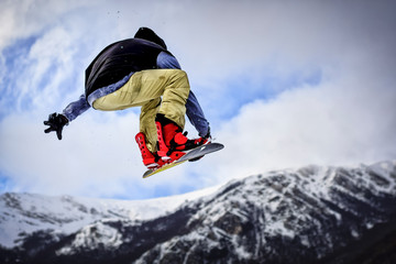 Jump with Snowboard in Backcountry