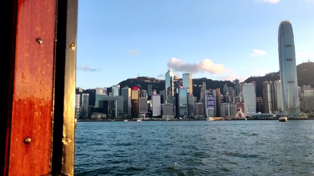 Inside a star ferry looking at Hong Kong Island and IFC during golden hour in Victoria Harbor, Hong Kong