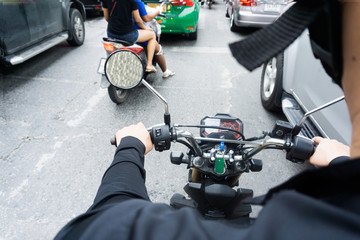 Man hands of motorcycle on a street.