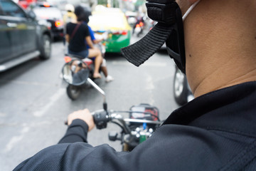 Man hands of motorcycle on a street.