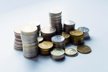 Columns of coins, piles of coins arranged on white background, business banking idea. Selective focus.