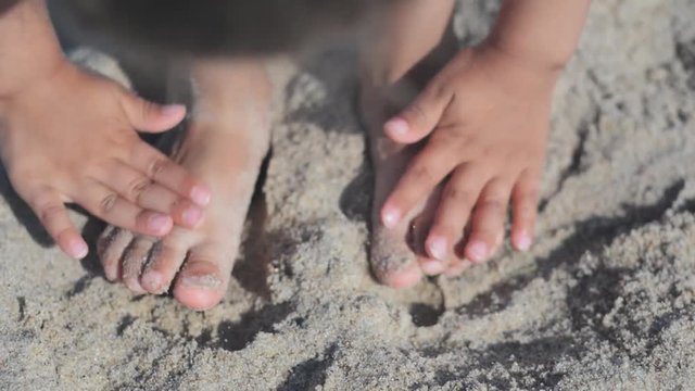 Baby feet on sand on the beach
