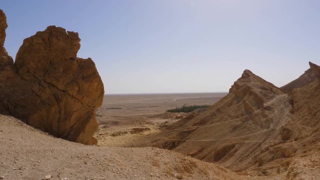 Mountain peaks of Atlas Mountains and Sahara desert landscape panoramic view. Panning shot