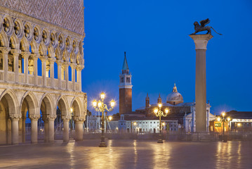Fototapeta na wymiar Venice night city view of Square Piazza San Marco, Doge's Palace, column of winged Lion, gondolas wharf and San Giorgio Maggiore island with basilica and campanile in light of streetlights