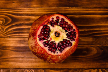 Fototapeta na wymiar Fresh ripe garnet fruit on wooden table. Top view