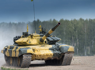 Military armored tank driving in mud at the open field