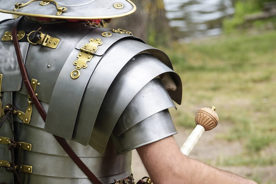 detail of an ancient roman soldier, legionnaire or centurion in metal armor at a historical festival, copy space