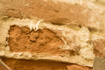 An old brick wall. Red-orange texture, antique surface.