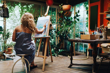 Woman painter painting in her painting studio.