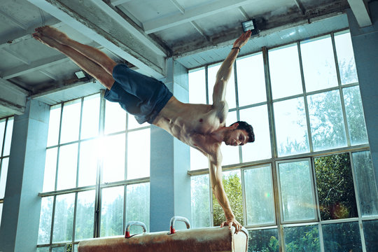 The sportsman during difficult exercise, sports gymnastics