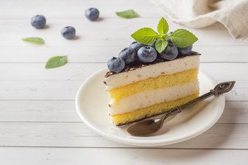 Cake of a souffle with glaze and fresh blueberries.
