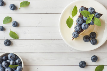 Cake of a souffle with glaze and fresh blueberries. Top view Copy space