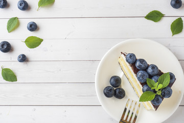 Naklejka na ściany i meble Cake of a souffle with glaze and fresh blueberries. Top view Copy space