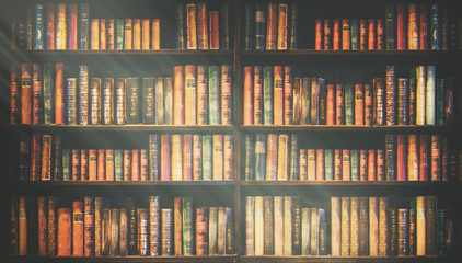 blurred bookshelf Many old books in a book shop or library. - obrazy, fototapety, plakaty