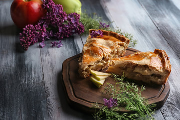 Pieces of apple pie on wooden board