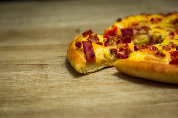 Hot pizza slice with melting cheese on a table in restaurant pizza Italian food.