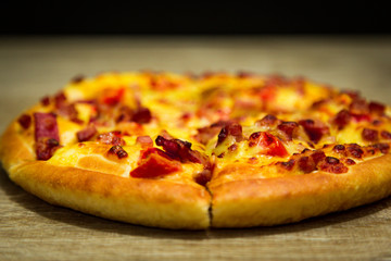 Hot pizza slice with melting cheese on a table in restaurant pizza Italian food.