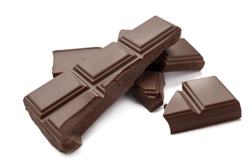 Delicious milk chocolate pieces on white background