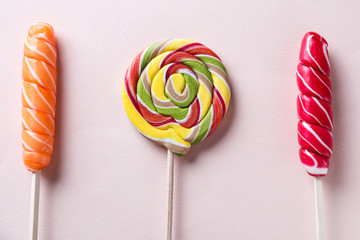 Delicious lollipops on light background